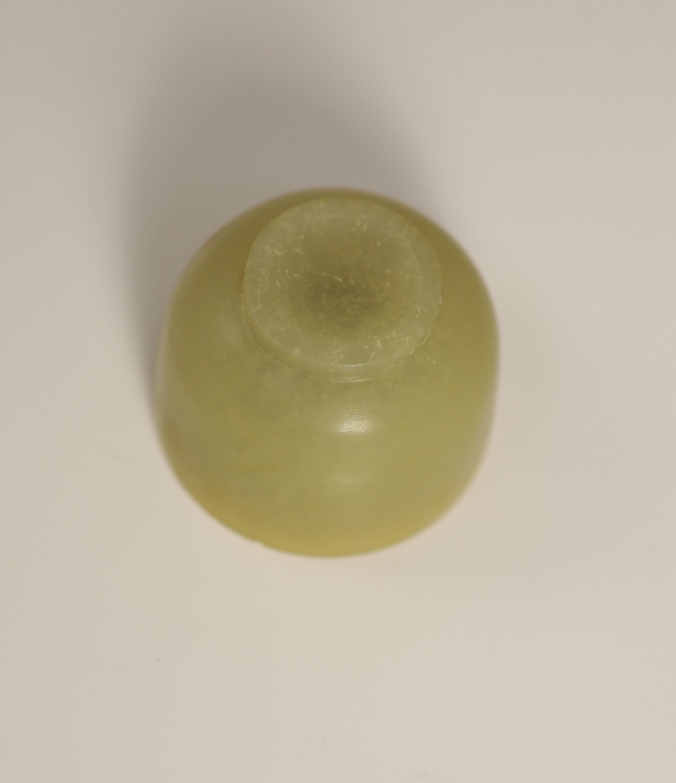 A Chinese yellow hardstone cup, 19th century, 5cm diameter, wood stand, rim chip